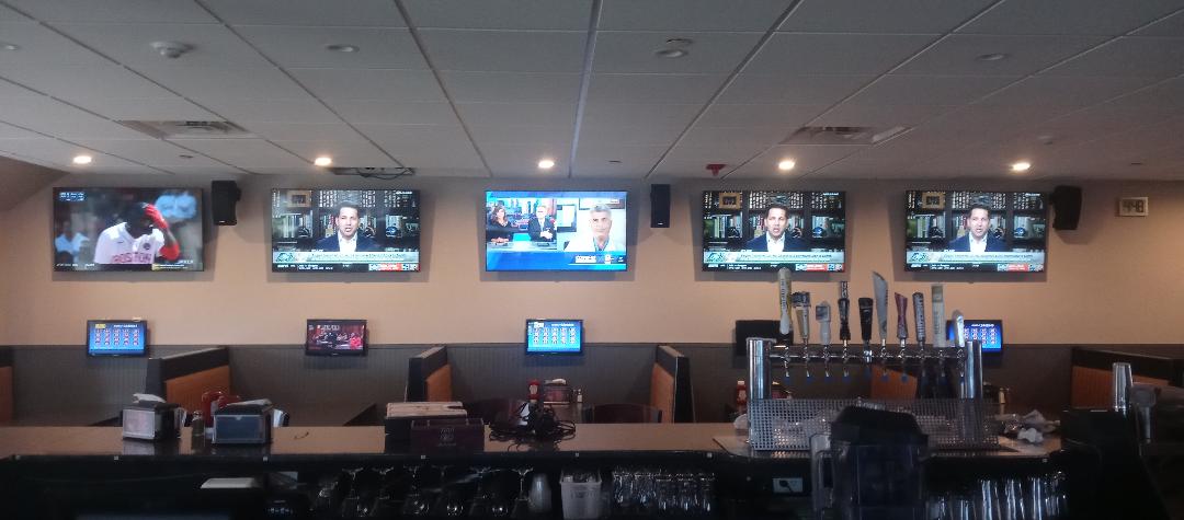 Multiple TVs mounted on wall